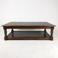 a wooden coffee table sitting on top of a hard wood floor