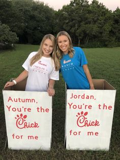 two girls standing in front of boxes with signs on them that say, jordan you're the chick for me