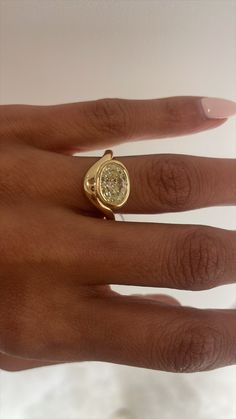 a woman's hand with a yellow diamond ring on it