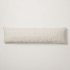 a white pillow on a white wall