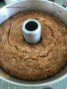 a cake in a pan with a cup on top