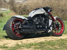 a white and red motorcycle parked in the grass