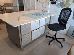 an office chair sitting at a desk with drawers