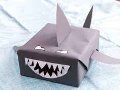 an origami box that looks like a shark with sharp teeth and big fangs