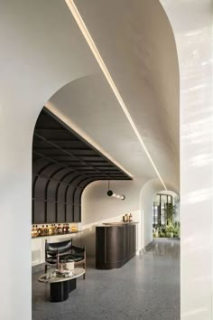 the interior of a restaurant with black and white decor on the walls, along with an arched ceiling