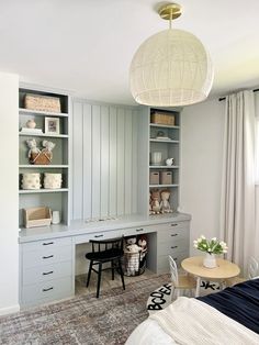 a bedroom with built in cabinets and desks