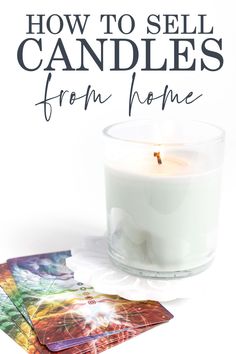 a candle sitting on top of a table next to some cards and a glass with the words how to sell candles from home