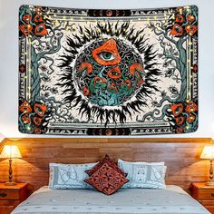 a large tapestry hanging on the wall above a bed