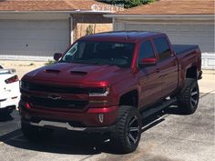 a red truck parked in front of a house