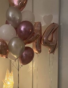 some balloons that are in the shape of numbers and stars on a table with other decorations