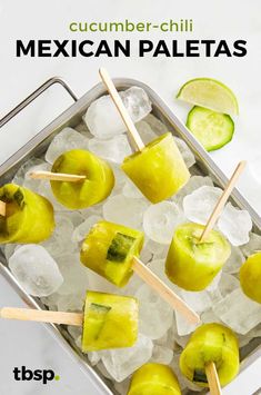 several pieces of fruit sitting on top of ice with toothpicks and limes