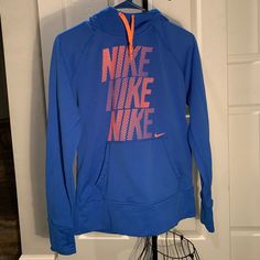 Nike Blue And Orange Ladies Therma Fit Hoodie. Includes A Front Pouch And Places To Put Your Thumbs In :) Perfect For Winter And Working Out! Size : Medium I’m Excellent Condition Like Brand New Blue Winter Workout Tops, Spring Workout Blue Outerwear, Blue Spring Workout Outerwear, Blue Spring Outerwear For Workout, Blue Sportswear Hoodie For Spring, Sporty Blue Hoodie For Fall, Blue Hooded Outerwear For Workout, Nike Blue Outerwear With Drawstring Hood, Blue Sportswear Sweatshirt For Fall