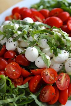 a salad with mozzarella and tomatoes on it