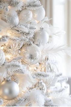 a white christmas tree with ornaments and lights