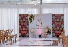 the ceremony room is decorated with chairs and flowers