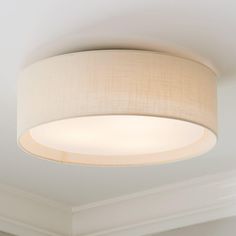 a round light fixture in a white room