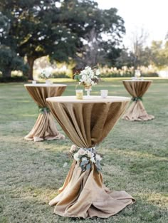 the tables are covered with burlocks and draping for an elegant look