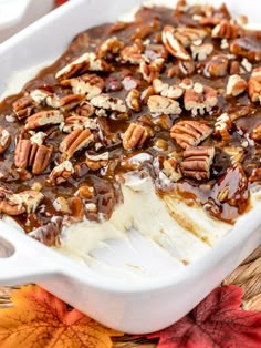 a white dish filled with ice cream and pecans