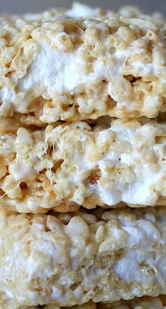 three rice krispy treats stacked on top of each other in front of another one