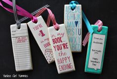 four decorated bookmarks with ribbons and writing on them