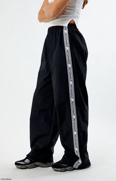 PacSun exclusive! Embrace effortless style with the Nylon Track Pants from Hot Wheels, perfect for racing into the day with flair. Crafted from lightweight woven nylon, they feature a striking contrast Hot Wheels stripe down the legs, side hand pockets, zipper ankle details, wide leg openings, and a relaxed baggy fit for ultimate comfort and versatility.


	Solid color track pants
	13" rise
	30.5" inseam
	22" leg opening
	High-rise
	Can sit low on the waist
	Elastic waistband
	Sid Nylon Track Pants, Track Pants Women, Birthday List, Baggy Fits, Pacsun, Track Pants, Effortless Style, Womens Bottoms, Wide Leg