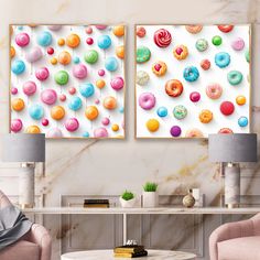 two canvases with colorful donuts on them in a living room next to a coffee table