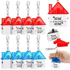 house shaped keychains are being held by someone's hand