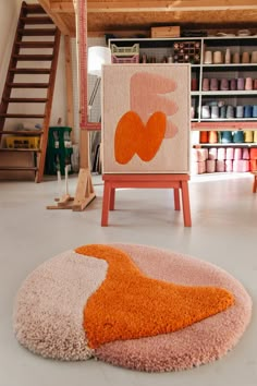 an orange and pink rug sitting on top of a floor next to a wooden ladder