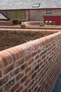 an old brick wall in front of a building