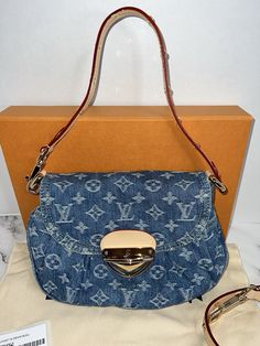 This Louis Vuitton Sunset Bag in Monogram Denim Remix M46829 is a limited edition piece perfect for travel or casual occasions. The bag features a push lock closure, gold hardware, and a detachable strap for versatility. The exterior is made of denim with the iconic monogram pattern and is accented with tan leather handles. The interior is lined in blue denim and includes an original box. This small crossbody bag measures 10.6 inches in width, 7.1 inches in height, and 1.2 inches in depth. The Louis Vuitton High model is designed for women and showcases the brand's signature style as a designer item. This bag is not vintage or customized. Complete set with tags, dust cover, original box with ribbon Hardware may have fine scratches. Smoke free home. No returns Luxury Bags With Turn-lock Closure In Monogram Canvas, Luxury Monogram Canvas Bag With Turn-lock Closure, Designer Satchel With Turn-lock Closure For Daily Use, Designer Bags With Turn-lock Closure For Daily Use, Monogram Canvas Shoulder Bag With Turn-lock For Everyday Use, Everyday Monogram Canvas Shoulder Bag With Turn-lock, Travel Bag With Monogram Canvas And Metal Hardware, Travel Bag With Metal Hardware And Monogram Canvas, Travel Bags With Metal Hardware And Monogram Canvas