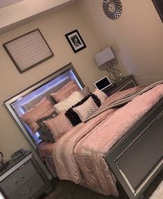 a bedroom with a bed, dresser and pictures on the wall