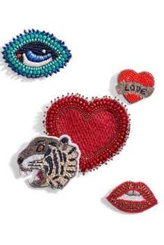 three pieces of beaded and sequind heart shaped brooches with different designs