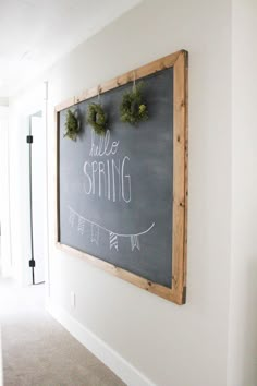 a chalkboard with the words hello spring written on it