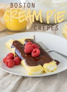 a white plate topped with ice cream and raspberries