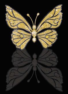 a yellow butterfly brooch sitting on top of a black surface