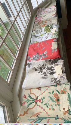 four different types of fabric sitting on top of a window sill next to each other