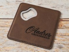 a brown leather bottle opener with an adress groomsman logo on the front