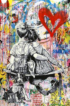 two people sitting on a bench in front of graffiti