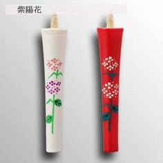 two toothbrushes decorated with flowers and leaves are shown in the same color as each other