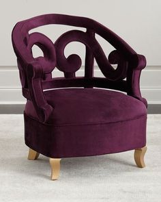 a purple chair sitting on top of a white carpet