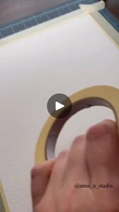 a person is making a video about how to use tape on canvass with scissors