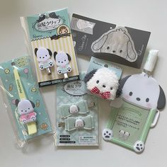 various items are laid out on a white surface, including an earphone and keychain