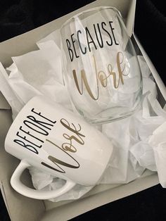 two coffee mugs sitting in a box with tissue paper on the floor next to them