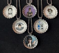 six bottle cap necklaces with pictures of people on them, hanging from a chain