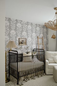 a baby's crib in the corner of a room with a white couch