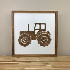 a wooden frame with an image of a tractor on the front, and a white background behind it