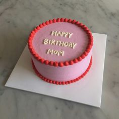 a pink birthday cake with the words happy birthday mom on it