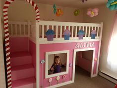 a child's bedroom with a pink and white bunk bed that has cupcakes on it