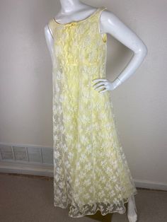 Lisiting as a SZ 6-8. please view all measurements. Dress is shown on a size 6 manikin dress is slightly roomy. Vintage butter yellow and white lace dress. This 70s style dress is empire waist style and very flattering. It has yards of lace overlay over a slim skirt. Dress is sleeveless and has details of plain yellow satin bow, and plain satin edging that goes all the way around the empire waist. The dress is hemmed and shown on a very tall Mannequin and can be hemmed to length needed. This Dress very well-made has slight amount of light pink stains on lace on left side of skirt if you were wearing dress. Possibly make up- not very noticeable I have tried to wipe off with baby wipes  dress looks very lightly used. Has original union tag inside. made in USA .  This would be cute wedding dr 70’s Yellow Wedding Dress, 70s Style Dress, Empire Yellow, 70s Fashion Dresses, Plain Yellow, Wedding Dr, Slim Skirt, Yellow Satin, Cute Wedding Dress