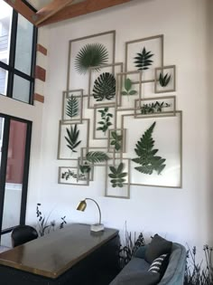 a living room filled with furniture and plants on the wall